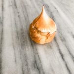 Gluten free lemon meringue cream puff on a marble table