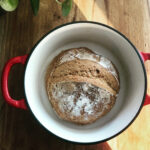 Loaf of gluten free bread in a red Dutch oven