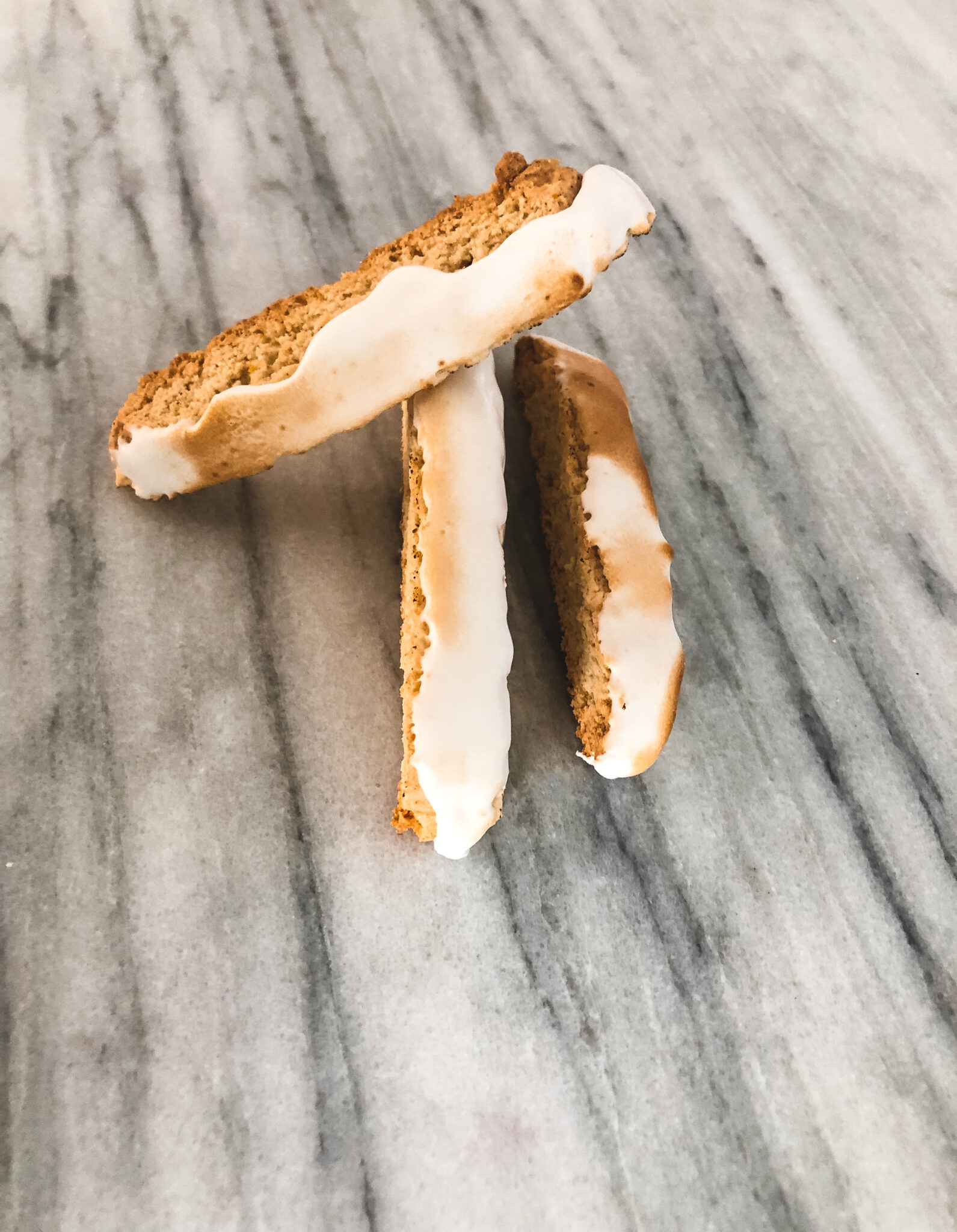 Gluten Free Lemon Meringue Biscotti on a marble table