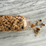 Gluten free granola spilling out of a mason jar