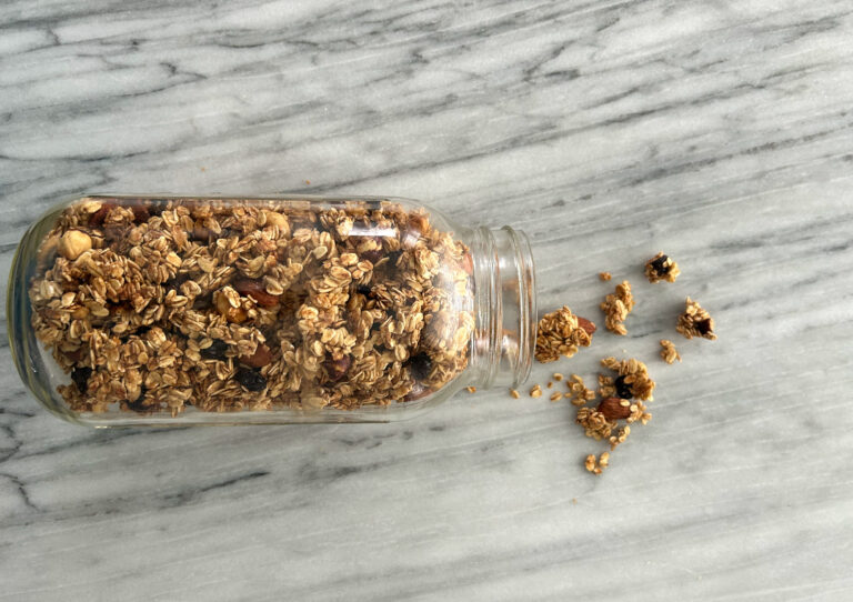 Gluten free granola spilling out of a mason jar