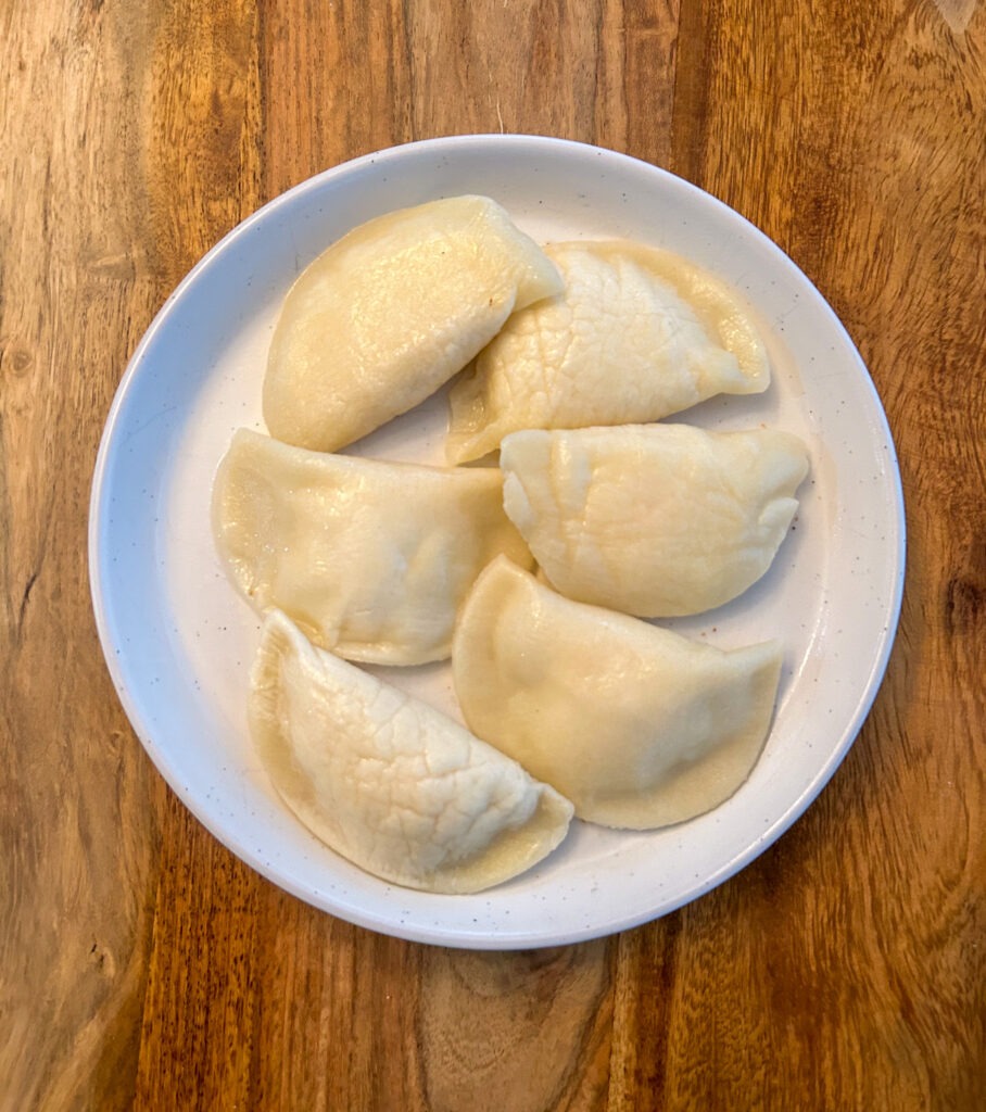 A plate of cooked perogies before they are pan fried. 