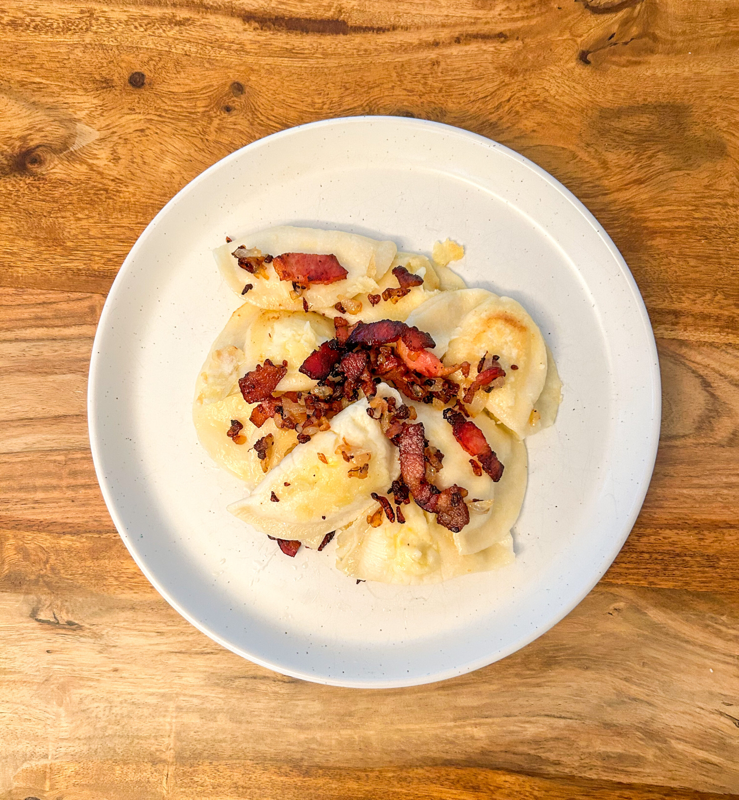 Plate of gluten free peroxides with bacon and onions. 