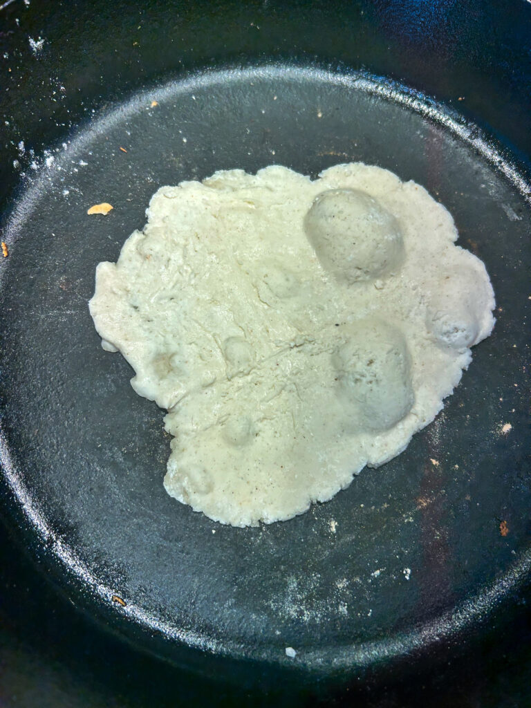 Gluten Free Naan That is cooking in a cast iron